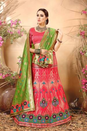 Look Pretty In This Pink Colored Lehenga Choli Paired With Contrasting Green Colored Dupatta. Its Blouse And Lehenga Are Fabricated On Jacquard Silk Beautified With Multi Colored Weave. It Is Light Weight And Easy To Carry All Day Long.
