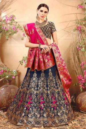 Enhance Your Personality Wearing This Lehenga Choli In Navy Blue Color Paired With Contrasting Dark Pink Colored Blouse. This Lehenga Choli And Dupatta Are Fabricated On Jacquard Silk Beautified With Weave. Buy This Lovely Piece Now.
