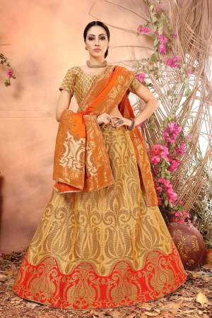 Simple And Elegant Looking Silk Lehenga Choli Is Here In Beige Color Paired With Contrasting Orange Colored Blouse. This Lehenga Choli And Dupatta Are Fabricated On Jacquard Silk Beautified With Weave All Over It. 