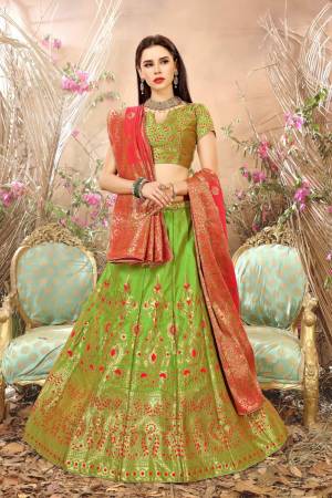 Grab This Pretty Silk Lehenga Choli In Light Green Color Paired With Contrasting Dark Peach Colored Blouse. This Lehenga Choli And Dupatta Are Fabricated On Jacquard Silk Beautified With Weave All Over. It Is Light Weight And Easy To Carry Throughout The Gala.
