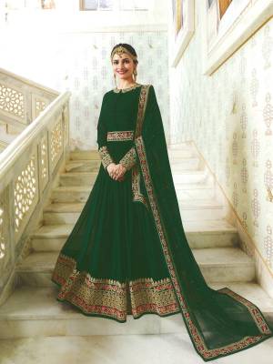 One Of The Finest Shade In Green Is Here With This Designer Floor Length Suit In Pine Green Color Paired With Pine Green Colored Bottom And Dupatta. Its Top Is Fabricated On Georgette Paired With Santoon Bottom And Chiffon Dupatta. It Has Heavy Multi Colored Embroidery Making The Suit More Attractive.