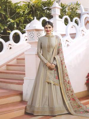 Flaunt Your Rich And Elegant Taste Wearing This Designer Floor Length Suit In Grey Colored Top Paired With Grey Colored Bottom And Grey Colored Dupatta. Its Top IS Fabricated On Art Paired With Santoon Bottom And Designer Net Fabricated Embroidered Dupatta. Buy Now.