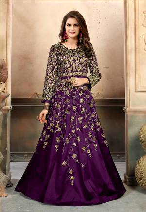 Add This Lovely Shade To Your Wardrobe With This Designer Floor Length Suit In Purple Color Paired With Purple Colored Bottom And Dupatta. Its Top Is Fabricated On Art Silk Paired With Santoon Bottom And Net Dupatta. It Is Beautified With Heavy Jari Embroidery And Stone Work. Buy Now.