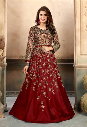 Beauty Like Never Before, Grab This Royal Looking Designer Floor Length Suit In Maroon Color Paired With Maroon Colored Bottom And Dupatta. Its Top Is Fabricated On Art Sik Paired With Santoon Bottom And Net Dupatta. Buy This Heavy Embroidered Suit Now.