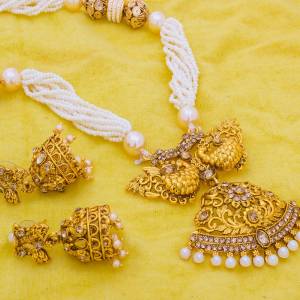 Here Is Beautiful Necklace Set In Golden Color With Two Beautiful Jhumka Earrings. It Is Beautified With Stone And Moti Work. Buy Now.