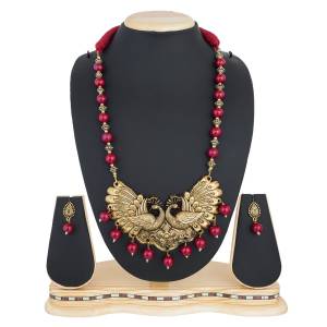 Old Is Gold, Grab This Holy Traditional Patterned Necklace Set In Golden Color Beautrified With Maroon Colored Moti.
