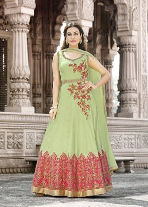 Get Ready For The Upcoming Festive Season With This Designer Floor Length Suit In Light Green Color Paired With Light Green Colored Bottom And Dupatta. Its Top Is Fabricated On Satin Cotton Paired With Santoon Bottom And Chiffon Dupatta. It Is Beautified With Contrasting Embroidery. Buy Now.