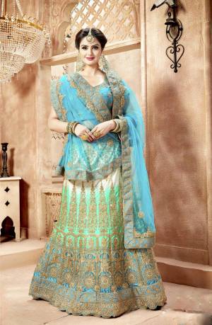 New Shades Are Up And In Trend In Designer Lehenga Cholis, Grab This Attractive Designer Lehenga Choli In Turquuoise Blue Colored Blouse Paired With Blue and Green Shaded Lehenga And Turquoise Blue Colored Dupatta, Also It Has Another Dupatta In Pastel Green Color. Its Blouse Is Fabricated On Art Silk Paired With Nylon Satin Lehenga And Net Fabricated Dupatta. Buy This Lehenga Choli Now.