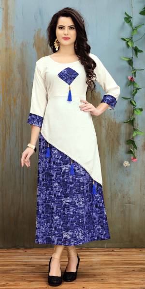 Grab This Lovely Readymade Kurti In White And Violet Color Fabricated On Rayon Cotton Beautified With Prints. This Kurti Is Light Weight And Easy To Carry All Day Long.
