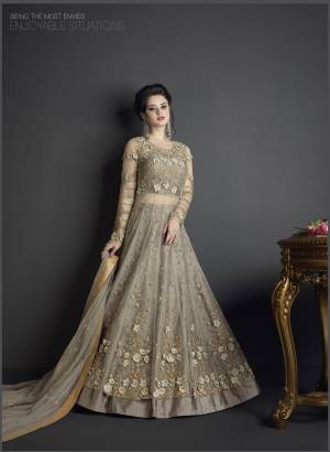 Flaunt Your Rich And Elegant Taste Wearing This Designer Suit In Grey Colored Top Paired With Grey Colored Bottom And Dupatta. Its Top Is Fabricated On Net Paired With Art Silk Fabricated Bottom And Net Fabricated Dupatta. Buy This Suit Now.It Is Beautiful Heavy Embroidery All Over Its Top Making The Suit More Attractive. 