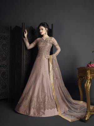 Here Is A Beautiful Shade In Purple With This Designer Suit In Mauve Color Paired With Mauve Colored Bottom And Dupatta. Its Top Is Fabricated On Net Paired With Art Silk Bottom And Net Dupatta. Buy This Lovely Suit Now.