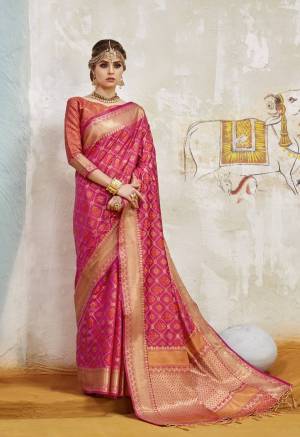 Shine Bright Wearing This Attractive And Rich Looking Silk Saree In Dark Pink Color Paired With Contrasting Orange Colored Blouse. This Saree And Blouse Are Fabricated On Art Silk Beautified With Weave All Over It. 