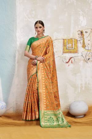 For A Proper Traditonal Look, Grab This Lovely Saree In Orange Color Paired With Contrasting Green Colored Blouse. This Saree And Blouse Are Fabricated On Art Silk Beautified With Weave All Over It. Its Traditional Colors And Fabric Will Give A Unique Look To Your Personality.