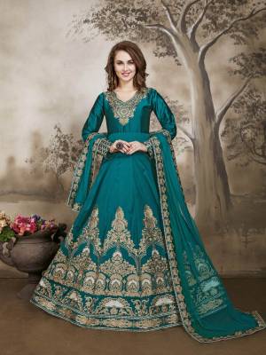 Add This Lovely Shade In Blue To Your Wardrobe With This Designer Floor Length Suit In Turquoise Blue Color Paired With Turquoise Blue Colored Bottom And Dupatta. Its Top Is Fabricated On Art Silk Paired With Santoon Bottom And Net Dupatta. Its All Three Fabrics Ensures Superb Comfort Throughout The Gala.
