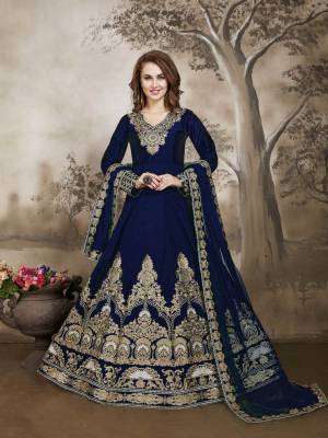 You Will Definitely Earn Lots Compliments Wearing This Designer Floor Length Suit In Navy Blue Color Paired With Navy Blue Colored Bottom And Dupatta. Its Top Is Fabricated On Art Silk Paired With Santoon Bottom And Net Dupatta. Buy Now.