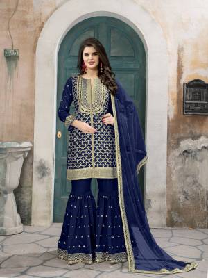 Shine Bright Wearing This Designer Sharara Suit Beautified With Heavy Jari Work .Its Top Is In Royal Blue Color Paired With Royal Blue Colored Sharara And Dupatta. Its Top And Bottom Are Fabricated On Art Silk Paired With Net Fabricated Dupatta. Buy This Pretty Suit Now.
