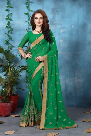 Celebrate This Festive Season Wearing This Saree In Green Color Paired With Green Colored Blouse. This Saree And Blouse Are Fabricated On Georgette Beautified With Jari Work. Buy This Saree Now.