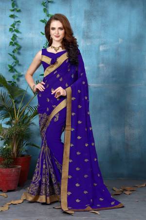 Add This New Shade To Your Wardrobe In Violet Color Paired With Violet Colored Blouse. This Saree And Blouse Are Fabricated On Georgette Beautified With Jari Embroidery All Over It. Buy This Saree Now.