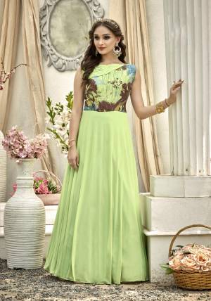 Simple And Elegant Looking Readymade Designer Gown Is Here In Light Green Color Fabricated On Fancy Fabric Beautified With Prints Over The Yoke. Buy Now.