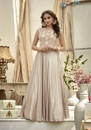 Flaunt Your Rich And Elegant Taste Wearing This Readymade Designer Gown In Cream Color Fabricated On Fancy Fabric. This Floor Lemgth Gown Is Light Weight And Easy To Carry All Day Long.