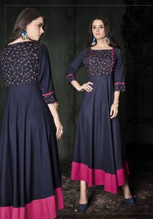 Add This Beautiful Designer Readymade Kurti To Your Wardrobe In Navy Blue Color Fabricated On Rayon Cotton Beautified With Prints. It Is Soft Towards Skin, Durable And Easy To Care For. 