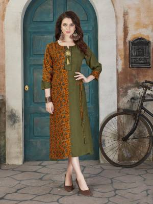 Grab This Beautiful Readymade Kurti In Olive Green And Musturd Yellow Color. This Pretty Kurti Is Fabricated On Rayon Cotton Beautified With Prints All Over It. Buy This Kurti Now.