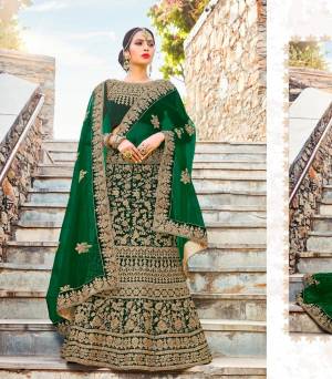 Celebrate This Festive Season Wearing This Heavy Designer Lehenga Choli In Dark Green Color Paired With Dark Green Colored Dupatta. Its Blouse And Lehenga Are fabricated On Velvet Paired With Net Fabricated Dupatta. It Is Beautified With Heavy Embrooidery All Over It. Buy This Now.