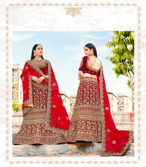 Adorn The Pretty Angelic Look This Wedding Season Wearing This Heavy Designer Lehenga Choli In Red Color Paired With Red Colored Dupatta. Its Blouse And Lehenga Are Fabricated On Velvet Paired With Net Fabricated Dupatta. This Attractive Lehenga Choli Will Definitely Earn You Lots Of Compliments From Onlookers.