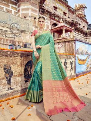 Here Is Very Pretty Sahde In Green With This sAree In sea Green color Paired With Contrasting Pink Colored Blouse. This Saree And Blouse Are fabricated On Banarasi Art Silk Beautified With Weave All Over It. Buy This Saree Now.