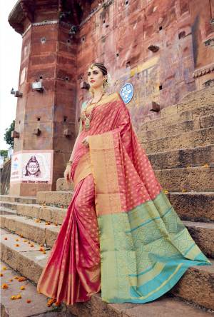 A Must Have Shade In Every Womens Weardrobe Is Here With This Saree In Dark Peach Color Paired With Contrasting Turquoise Blue Colored Blouse. This Saree And Blouse Are Fabricated On Banarasi Art Silk Beautified With Weave All Over It. Buy This Saree Now.