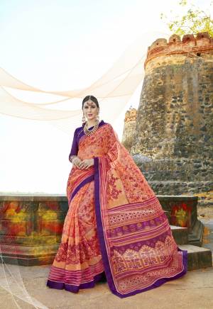 Shine Bright Wearing this Pretty Attractive Saree In Orange And Pink Color Paired With Contrasting Purple Colored Blouse. This Saree Is Fabricated On Super Net Cotton Paired With Art Silk Fabricated Blouse. This Saree Is Beautified With Prints And Thread Work.