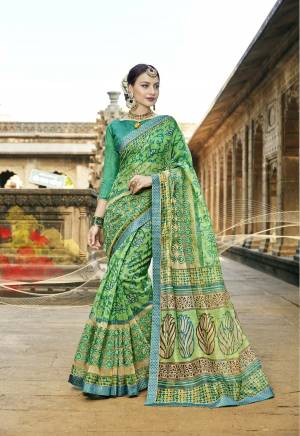 Grab This Pretty Saree In Green Color Paired With Sea Green Colored Blouse. This Saree Is Fabricated On Super Net Cotton Paired With Art Silk Fabricated Blouse. This Saree Is Light In Weight And Easy To Carry All Day Long.