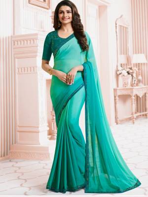 Shades Are In This Season, So Grab This Cool Colored Pallete Saree In Shades Of Aqua Blue Paired With Teal Blue Colored Blouse. This Saree Is Fabricated On Georgette Paired With Art Silk Fabricated Blouse. It Is Light In Weight And Easy To Carry All Day Long.