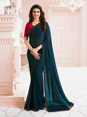 New And Beautiful Shade Is Here In Blue With This Saree In Prussian Blue Color Paired With Contrasting Dark Pink Colored Blouse. This Saree Is Fabricated On Georgette Paired With Art Silk Fabricated Blouse. It Is Easy To Carry All Day Long And Also It Enusres Superb Comfort.