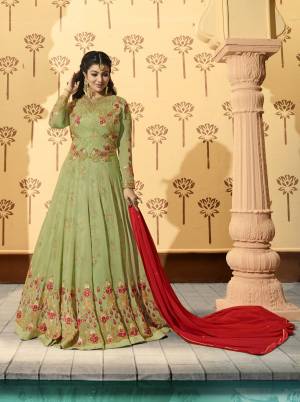 Celebrate This Festive Season Wearing This Designer Floor Length Suit In Light Green Colored Top Paired With Light Green Colored Bottom And Contrasting Red Colored Dupatta. Its Top Is Fabricated On Georgette Paired With Santoon Bottom And Chiffon Dupatta. Its all Three Fabrics Ensures Superb Comfort All Day Long.