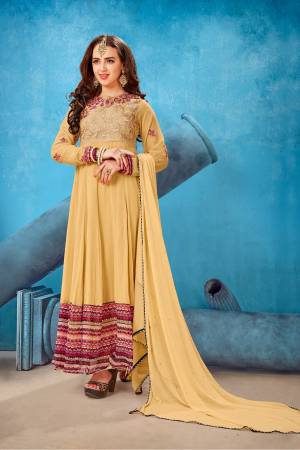 Get Ready For The Upcoming Festive Season With This Designer Suit In Beige Color Paired With Beige Colored Bottom And Dupatta. Its Top Is Fabricated On Georgette Paired With Santoon Bottom And Chiffon Dupatta. It Has Beautiful Embroidery Over The Yoke And Sleeves.