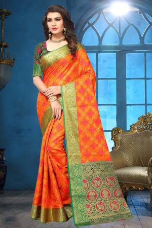 Shine Bright Wearing This Designer Silk Saree In Orange Color Paired With Contrasting Dark Green Colored Blouse. This Saree Is Fabricated On Jacquard Silk Paired With Art Silk Fabricated Blouse Beautified With Weave. 