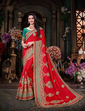 Adorn The Pretty Angelic Look Wearing This Saree In Red Color Paired With Contrasting Sea Green Colored Blouse. This Saree Is Fabricated On Art Silk Paired With Art Silk Fabricated Blouse. It Has Attractive detailed Embroidery All Over. Buy Now.