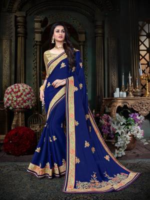 Bright And Visually Appealing Color Is Here With this Saree In Royal Blue Color Paired With Contrasting Sea Green Colored Blouse. This Saree Is Fabricated On Georgette Paired With Art Silk Fabricated Blouse. It Has Lovely Multi Colored Embroidery All Over.