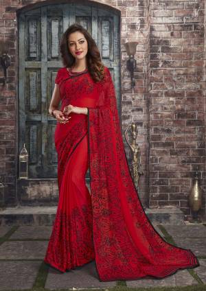 Adorn The Pretty Angelic Look Wearing This Saree In Red Color Paired With Red Colored Blouse. This Saree And Blouse Are Fabricated On Chiffon Beautified With Simple Floral Prints All Over It. This Saree Is Light In Weight And Also Easy To Carry All Day Long. 