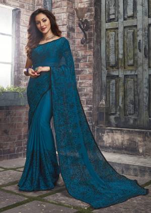 Adorn The Pretty Angelic Look Wearing This Saree In Blue Color Paired With Blue Colored Blouse. This Saree And Blouse Are Fabricated On Chiffon Beautified With Simple Floral Prints All Over It. This Saree Is Light In Weight And Also Easy To Carry All Day Long. 