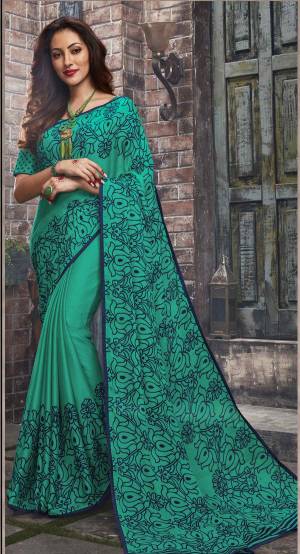Adorn The Pretty Angelic Look Wearing This Saree In Sea Green Color Paired With Sea Green Colored Blouse. This Saree And Blouse Are Fabricated On Chiffon Beautified With Simple Floral Prints All Over It. This Saree Is Light In Weight And Also Easy To Carry All Day Long. 