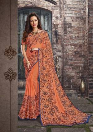 Adorn The Pretty Angelic Look Wearing This Saree In Light Orange Color Paired With Light Orange Colored Blouse. This Saree And Blouse Are Fabricated On Chiffon Beautified With Simple Floral Prints All Over It. This Saree Is Light In Weight And Also Easy To Carry All Day Long. 