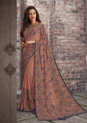 Adorn The Pretty Angelic Look Wearing This Saree In Beige Color Paired With Beige Colored Blouse. This Saree And Blouse Are Fabricated On Chiffon Beautified With Simple Floral Prints All Over It. This Saree Is Light In Weight And Also Easy To Carry All Day Long. 