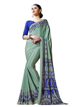 Here Is A Lovely Pastel Shade In Green With This Saree In Pastel Green Color Paired With Contrasting Royal Blue Colored Blouse. This Saree And Blouse are Fabricated On Crepe Beautified With Prints All Over It.