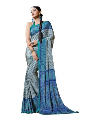 Simple Saree Is Here For Your Casual Wear In White And Blue Color Paired With Turquoise Blue Colored Blouse. This Saree And Blouse Are Fabricated On Crepe Beautified With Prints All Over It, Buy This Saree Now.