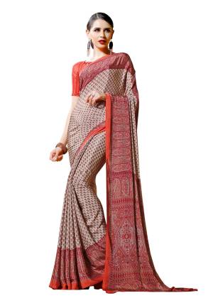 Add This Pretty Simple Saree To Your Wardrobe In Cream And Orange Color Paired With Orange Colored Blouse. This Saree And Blouse are Fabricated On Crepe Beautified With Prints All Over It.