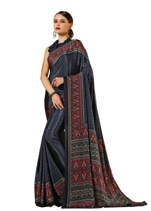 For A Bold And Beautiful Look, Grab This Saree In Black Color Paired With Black Colored Blouse. This Saree And Blouse Are Fabricated On Crepe Beautified With Prints All Over It.