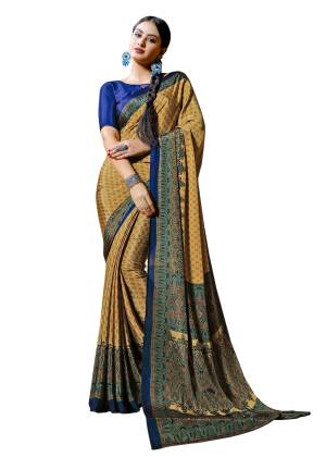 You Must Have Some Casuals To Your Wardrobe, Grab This Pretty Saree In Beige And Yellow Color Paired With Contrasting Royal Blue Colored Blouse. This Saree And Blouse are Fabricated On Crepe Beautified With Prints all Over.