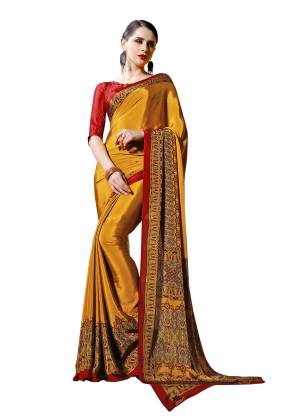 Celebrate This Festive Season With Beauty And Comfort Wearing This Saree In Musturd Yellow Color Paired With Contrasting Red Colored Blouse. This Saree And Blouse Are Fabricated On Crepe Beautified With Prints All Over.